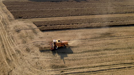 Aerial-Flight-Over-The-Harvest-Machine-During-Work-on-agricultural-field