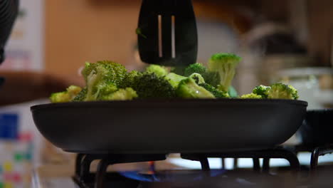Stirring-broccoli-on-the-stove-top-for-a-homemade-meal---slow-motion-low-angle