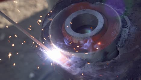 Welding-with-Electrode-a-Circle-Piece-of-Metal---Close-Shot-Slowmo