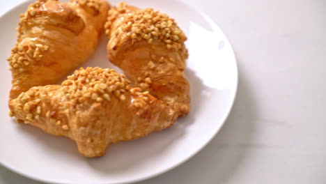 fresh-croissant-with-peanut-on-plate