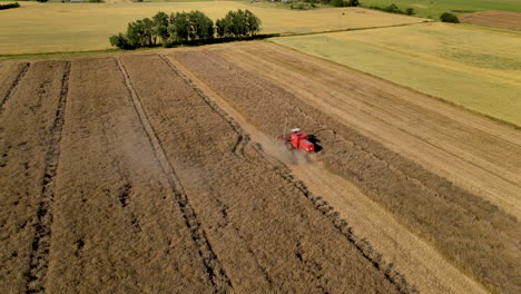 Combine-Harvester-Gathers-The-Wheat-Crop-during-beautiful-sunny-day,aerial-view