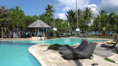 Sun-Loungers-By-The-Pool-Side-In-Dos-Palmas-Island-Resort,-Palawan