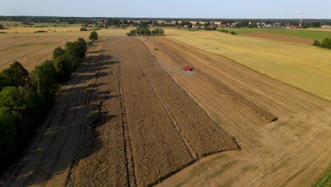 Dramatic-farming-landscape-near-Mlynary-Poland-as-combine-harvesters-work-the-land