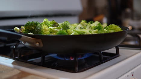 Skillet-full-of-freshly-cut-broccoli-cooking-on-the-stove-top---slow-motion