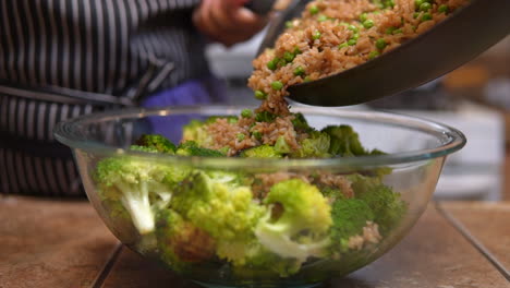 Adding-fried-rice-to-stir-fry-broccoli-for-a-delicious-meal---slow-motion