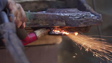 Man´s-Hand-Holding-a-Blowtorch-Tool-Welding-Metal---Slowmotion