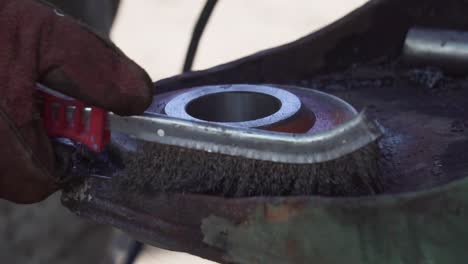 Steel-Brush-Cleaning-a-Metal-Surface-before-Welding---Close-Shot-Slowmotion