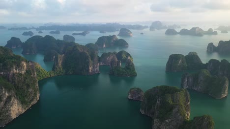 Breathtaking-Aerial-View-of-Bai-Tu-and-Ha-Long-Bay-Unesco-World-Heritage-Vietnam-,-Famous-Scenic-Archipelago-and-Sea-at-Evening,-Drone-Shot