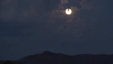A-spring-time-day-to-night-timelapse-of-a-moon-rise-behind-puffy-clouds-in-the-Appalachian-hills