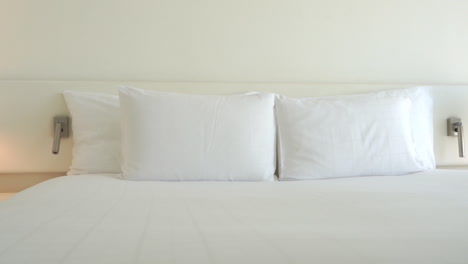 Pan-across-the-wide-of-a-large-comfortable-hotel-bed