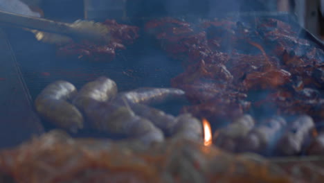Shallow-focus-tight-shot-of-meats-on-a-very-smoky-BBQ-grill