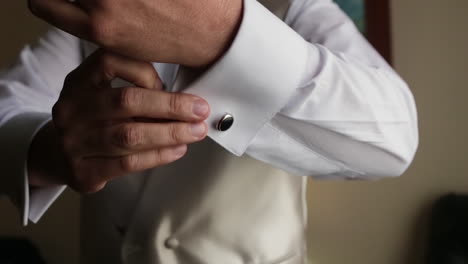Close-up-of-male-hands-putting-a-cufflink-getting-ready-for-event