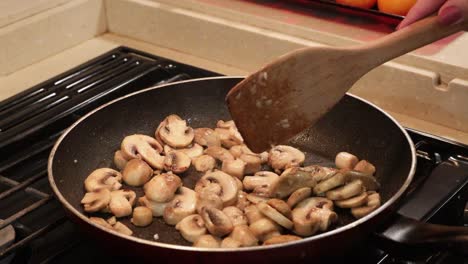 Sauteing-sliced-button-mushrooms-in-butter-and-garlic