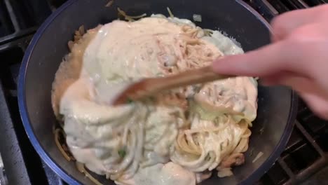 Cooking-pasta-with-a-white-and-creamy-Alfredo-sauce