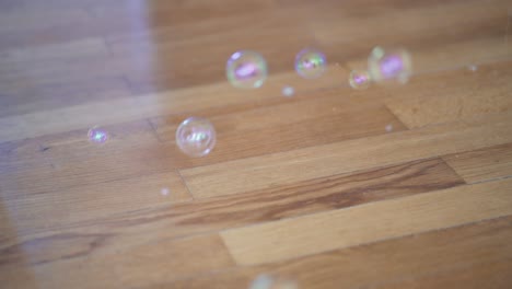 Corona-Bubbles-Popping-Out-Of-The-Wooden-Floor,-Signifying-Footsteps-Of-People-That-Had-Close-Physical-Contact-With-A-Covid-19-Person---close-up