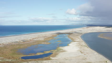 Aerial-View-of-Standing-Water-on-Mangawhai-Beach-in-New-Zealand