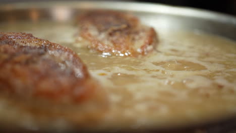 Golden-brown-chicken-breasts-simmering-in-a-savory-sauce---close-up-slow-motion