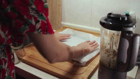 Woman-puts-wax-paper-on-baking-pan
