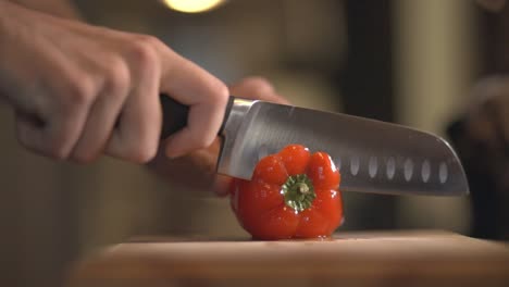 Chef's-Hand-Slicing-A-Red-Sweet-Bell-Pepper-To-Remove-The-Seeds