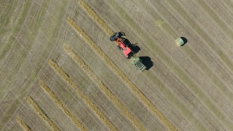 Overhead-birdseye-view-of-tractor-making-bales-of-hay-in-the-field