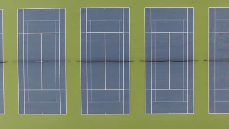 Top-down-aerial-shot-of-many-tennis-courts,-no-people,-nobody,-no-one,-sports-theme-athletics