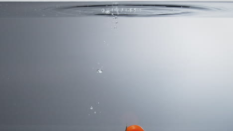 Cherry-tomatoes-falling-into-clear-water