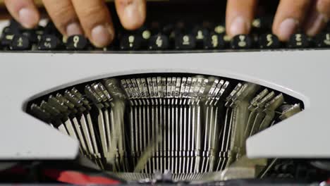 Close-Up-Over-The-Top-View-Of-Models-Fingers-Using-Typewriter-Focus-On-Type-bars-In-Motion