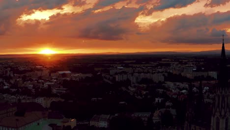 Aerial-View-of-Idyllic-Summer-Sunset-and-Dramatic-Sky-Above-Small-European-City