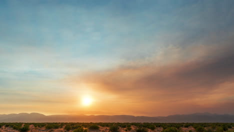 Farbenfroher-Wüstenzeitraffer-Während-Eines-Heißen,-Goldenen-Sonnenuntergangs-Mit-Gefiederten,-Wispy-Wolken