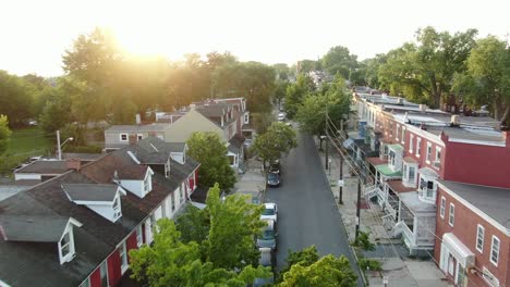 Aerial-establishing-shot-of-low-income-urban-housing,-homes-in-United-States-city,-American-real-estate-during-dramatic-sunset