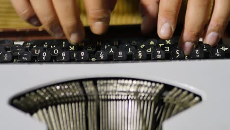 Close-Up-Over-The-Top-View-Of-Typist-Using-Vintage-Typewriter-Focus-On-Typist's-Fingers