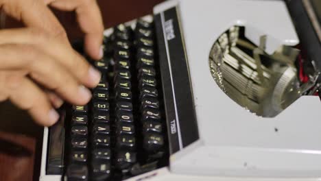 Profile-View-Of-Typist-Testing-Out-Vintage-Typewriter-With-Type-Bars-In-Motion