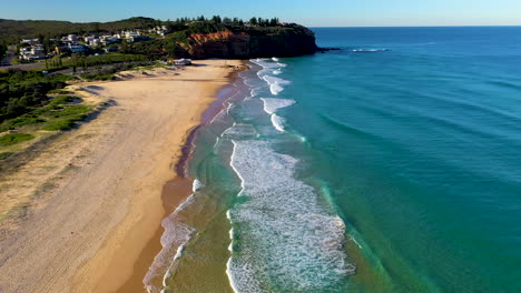 Revealing-drone-shot-of-waves-and-beach-at-Redhead-beach-Australia