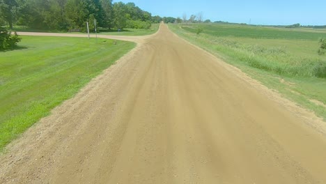 POV-driving-on-a-gravel-road-and-turning-into-a-rural-county-park