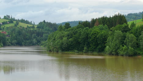 Moving-water-on-the-surface-of-the-reservoir-during-the-day-with-the-surrounding-nature-full-of-forests-and-trees-on-the-edges-of-the-Bystricka-reservoir