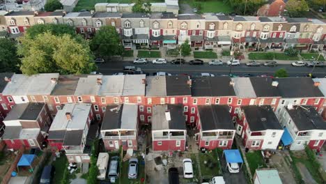Aerial-establishing-shot-of-row-homes,-houses-tightly-packed-along-street-in-USA,-American-housing-real-estate-in-urban-America-during-magic-hour