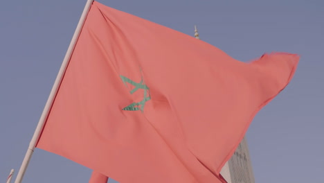 Close-up-of-Moroccan-flag-flying-in-front-of-Hassan-II-Mosque,-in-Casablanca