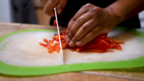 Dicing-red-peppers-for-a-fresh,-vegetarian-meal---slow-motion-slide