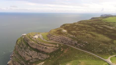 Aerial-view-flying-above-Great-Orme-coastline-highlands-Llandudno-mountain-valley-rural-landscape