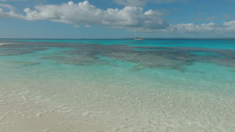 Clear-ocean-with-tropical-reef-and-yacht