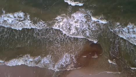 Epic-Aerial-Drone-Footage-Of-Waves-Breaking-Onto-A-Golden-Sandy-Beach-during-covid19
