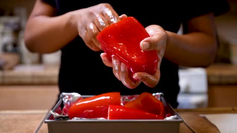 Hand-rubbing-olive-oil-on-bell-peppers-for-stuffing---slow-motion