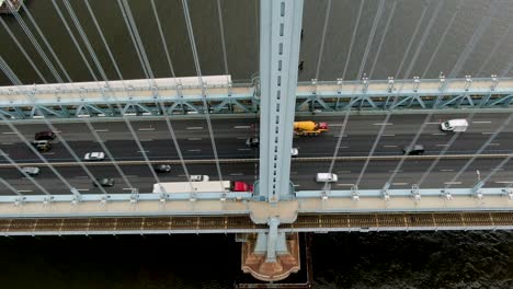 Static-aerial-shot-of-traffic-on-Ben-Franklin-Bridge-in-Philadelphia,-transportation,-commute-concept,-bridge-girder-bisects-view