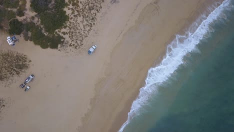 Aerial-ascending-shot-of-Todos-Santos-beach-camping-in-Baja-California