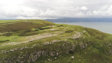 Aerial-view-flying-above-Great-Orme-Llandudno-mountain-valley-rural-landscape-orbit-right
