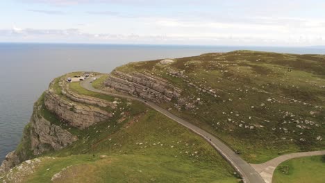 Aerial-view-flying-above-Great-Orme-Llandudno-mountain-valley-rural-coastline-cliff-landscape