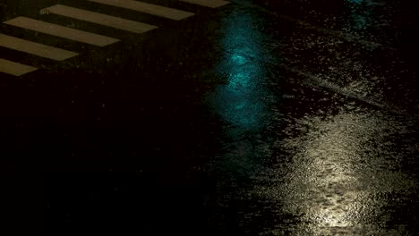 Cars-passing-a-crossroads-during-heavy-rain-with-city-light-reflections