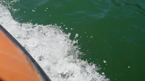 Water-Splashing-As-A-Powerboat-Is-Speeding-On-The-Calm-Blue-Sea-On-A-Summer-Day---overhead-shot