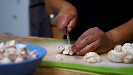 Slicing-and-dicing-fresh,-organic-mushrooms-for-a-homemade-recipe---slow-motion