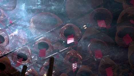 Slow-motion-footage-of-incense-coils-hanging-from-the-ceiling-as-they-burn-inside-a-Taoist-temple-to-attract-the-attention-of-the-gods-in-Hong-Kong